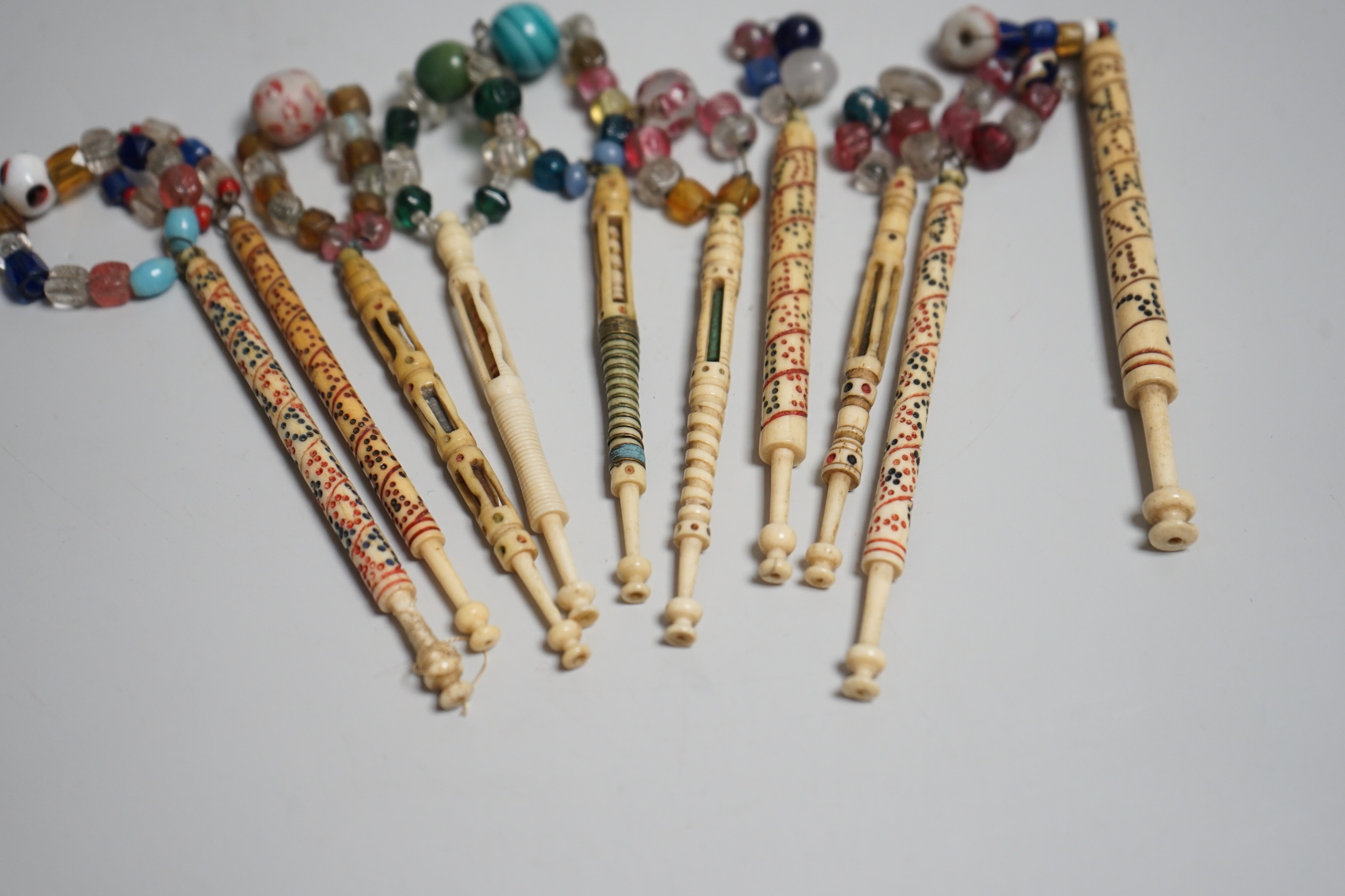 Five 19th century unusual reticulated bone lace bobbins with diagonal messages and five other ornately carved bobbins (10)